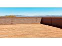 Large backyard area with block wall fence and potential for landscaping at 11948 E Aster Ln, Florence, AZ 85132