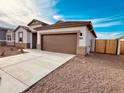 Charming single-story home with a spacious driveway and low-maintenance desert landscaping for relaxed living at 11948 E Aster Ln, Florence, AZ 85132