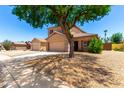 Beautiful single-Gathering home featuring desert landscaping, a two-car garage, and a well-maintained lawn at 15427 W Port Au Prince Ln, Surprise, AZ 85379