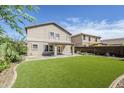 The backyard offers a spacious lawn and covered patio, perfect for outdoor enjoyment at 1839 E Parkside Ln, Phoenix, AZ 85024
