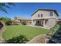 This backyard has an expansive lawn and patio area for relaxing and entertaining at 1839 E Parkside Ln, Phoenix, AZ 85024