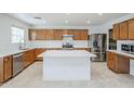 The kitchen has an island, stainless steel appliances, and ample cabinet space at 1839 E Parkside Ln, Phoenix, AZ 85024