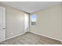 Cozy bedroom featuring neutral carpet, one window, and a closet door at 19026 W Stella Ave, Waddell, AZ 85355