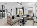 Cozy living room with tile floors, neutral furniture, and backyard access at 19407 W Pierson St, Litchfield Park, AZ 85340