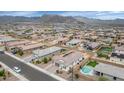 An aerial view of a home with a backyard pool and mountain views at 19806 W Marshall Ave, Litchfield Park, AZ 85340