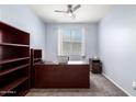 Office space with carpeted floors, neutral walls and a dark wood desk at 21648 W Ashleigh Marie St, Buckeye, AZ 85326