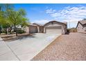 Inviting single-story home with a well-kept yard, long driveway and a three-car garage at 22926 W Yavapai St, Buckeye, AZ 85326