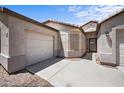 The exterior showcases a driveway leading to a garage and entry, featuring desert landscaping at 22926 W Yavapai St, Buckeye, AZ 85326
