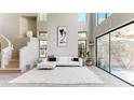 Spacious living area featuring high ceilings, large windows, and a comfortable seating arrangement at 25555 N Windy Walk Dr # 64, Scottsdale, AZ 85255