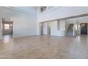 Spacious living room with tile flooring, high ceilings and staircase access to upper floors at 30277 N 125Th Ln, Peoria, AZ 85383