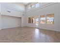 Sunlit living room with high ceilings, large windows and tile flooring throughout at 30277 N 125Th Ln, Peoria, AZ 85383