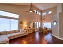 Open living and dining space featuring high ceilings, hardwood floors, and comfortable furniture at 31256 N 40Th Pl, Cave Creek, AZ 85331