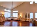 Bright living room featuring hardwood floors, high ceilings, many windows, and a comfortable sectional sofa at 31256 N 40Th Pl, Cave Creek, AZ 85331