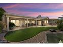 Beautiful backyard view with covered patio and lush landscaping at 3394 N 147Th Ln, Goodyear, AZ 85395