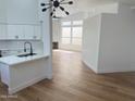 Open-concept living area featuring modern lighting, wood flooring, a fireplace, and large windows at 3440 E Southern Ave # 1107, Mesa, AZ 85204
