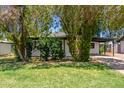 The house is surrounded by mature trees and a well-maintained green lawn at 3526 E Cheery Lynn Rd, Phoenix, AZ 85018