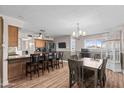 Open concept dining area showcases stylish light fixture and wood-look floors at 3636 W Crocus Dr, Phoenix, AZ 85053