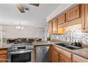 Kitchen features updated stainless steel appliances and a breakfast bar at 3636 W Crocus Dr, Phoenix, AZ 85053