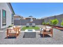 Serene backyard with a fire pit and outdoor seating at 37903 W San Clemente St, Maricopa, AZ 85138