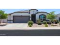 Charming single-story home featuring a two-car garage and beautiful desert landscaping at 37903 W San Clemente St, Maricopa, AZ 85138