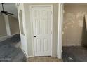 View of entryway, including door and arched wall, showing design and natural light at 43213 W Cowpath Rd, Maricopa, AZ 85138
