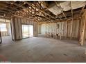 Interior framing for a new home showing insulation, open floor plan, and sliding glass door at 47450 W Kenner Dr, Maricopa, AZ 85139