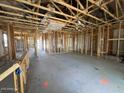 Interior framing of a new home shows studs and an open floor plan at 47450 W Kenner Dr, Maricopa, AZ 85139