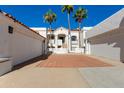 Stunning Spanish-style home with terracotta roof, white stucco walls, and palm trees, embodying elegance at 6138 N 28Th St, Phoenix, AZ 85016