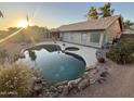 Relaxing backyard featuring a large pool and spa with a covered patio, perfect for entertaining at 6623 E Preston St, Mesa, AZ 85215