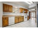 Traditional kitchen featuring wood cabinets, white appliances, and tile flooring at 7424 E Cambridge Ave, Scottsdale, AZ 85257