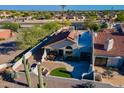 Charming backyard with a small grass area and plenty of space for entertaining under the Arizona sun at 8950 E Greenview Dr, Gold Canyon, AZ 85118