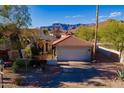 Stunning single-story desert home featuring a stucco exterior, tile roof, and well-maintained landscaping at 8950 E Greenview Dr, Gold Canyon, AZ 85118