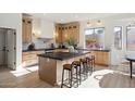 Bright kitchen featuring a large island with seating and plenty of natural light at 9322 E Hidden Green Dr, Scottsdale, AZ 85262