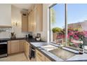 Well-lit kitchen featuring a sink with a view and modern fixtures at 9322 E Hidden Green Dr, Scottsdale, AZ 85262