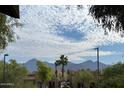 Beautiful mountain view with puffy clouds and clear blue sky from this community's well-maintained landscaping at 9745 N 95Th St # 227, Scottsdale, AZ 85258