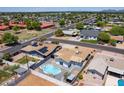 Aerial view of property featuring a backyard pool, mature landscaping, and nearby residential area at 1011 W Weldon Ave, Phoenix, AZ 85013