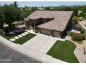 Aerial view of the home showing the three car garage, tile roof and manicured landscaping at 1092 N Roosevelt Ave, Chandler, AZ 85226