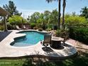 An outdoor pool features a seating area and fire pit with lush greenery at 1092 N Roosevelt Ave, Chandler, AZ 85226