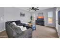 Cozy living room with soft lighting, comfortable furniture, TV, and modern ceiling fan at 14250 W Wigwam Blvd # 2722, Litchfield Park, AZ 85340
