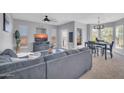 Comfortable living room with modern gray furniture, TV, ceiling fan and lots of light at 14250 W Wigwam Blvd # 2722, Litchfield Park, AZ 85340