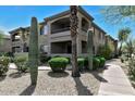 Two-story condo building featuring desert landscaping, private balconies, and covered entryways at 14815 N Fountain Hills Blvd # 101, Fountain Hills, AZ 85268