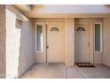 Close up of townhouse entrance with two front doors under covered entryway and desert landscaping at 16021 N 30Th St # 122, Phoenix, AZ 85032