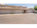 Attractive townhouse featuring a beige facade, two-car garage, and tiled roof at 16021 N 30Th St # 122, Phoenix, AZ 85032