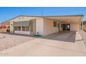 Single-story home with covered parking, concrete driveway, and desert landscaping at 16215 N 35Th Way, Phoenix, AZ 85032