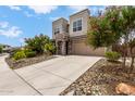 Stunning two-story home with a large driveway and well-manicured desert landscaping at 16539 W Winston Dr, Goodyear, AZ 85338