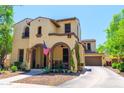 Two-story home with arched porch, neutral stucco, desert landscaping, and attached garage in a sunny setting at 20639 W Grandview Dr, Buckeye, AZ 85396