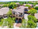Beautiful two-story home featuring a tiled roof, a charming front porch, and a well-maintained landscape at 20639 W Grandview Dr, Buckeye, AZ 85396