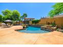 Inviting backyard pool and patio area, great for relaxation and entertainment with views of the two-story home at 20639 W Grandview Dr, Buckeye, AZ 85396
