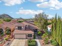 Aerial view of a two-story home showcasing the landscaping, roof, and mountain views at 2114 E Escuda Rd, Phoenix, AZ 85024