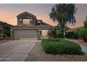 Two story home at dusk with a two car garage and mature landscaping at 2114 E Escuda Rd, Phoenix, AZ 85024